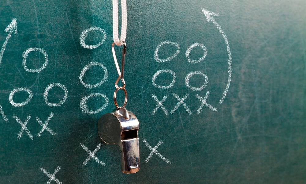 Chalkboard with football scheme and hanging whistle. Sporting official background check concept.